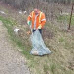 PW Manager Brad Thake picking up garbage out of the ditch