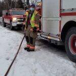 Firefighter flooding a rink