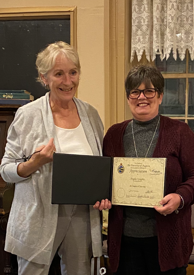 Angela Knight receiving a certificate from Michele Bowman
