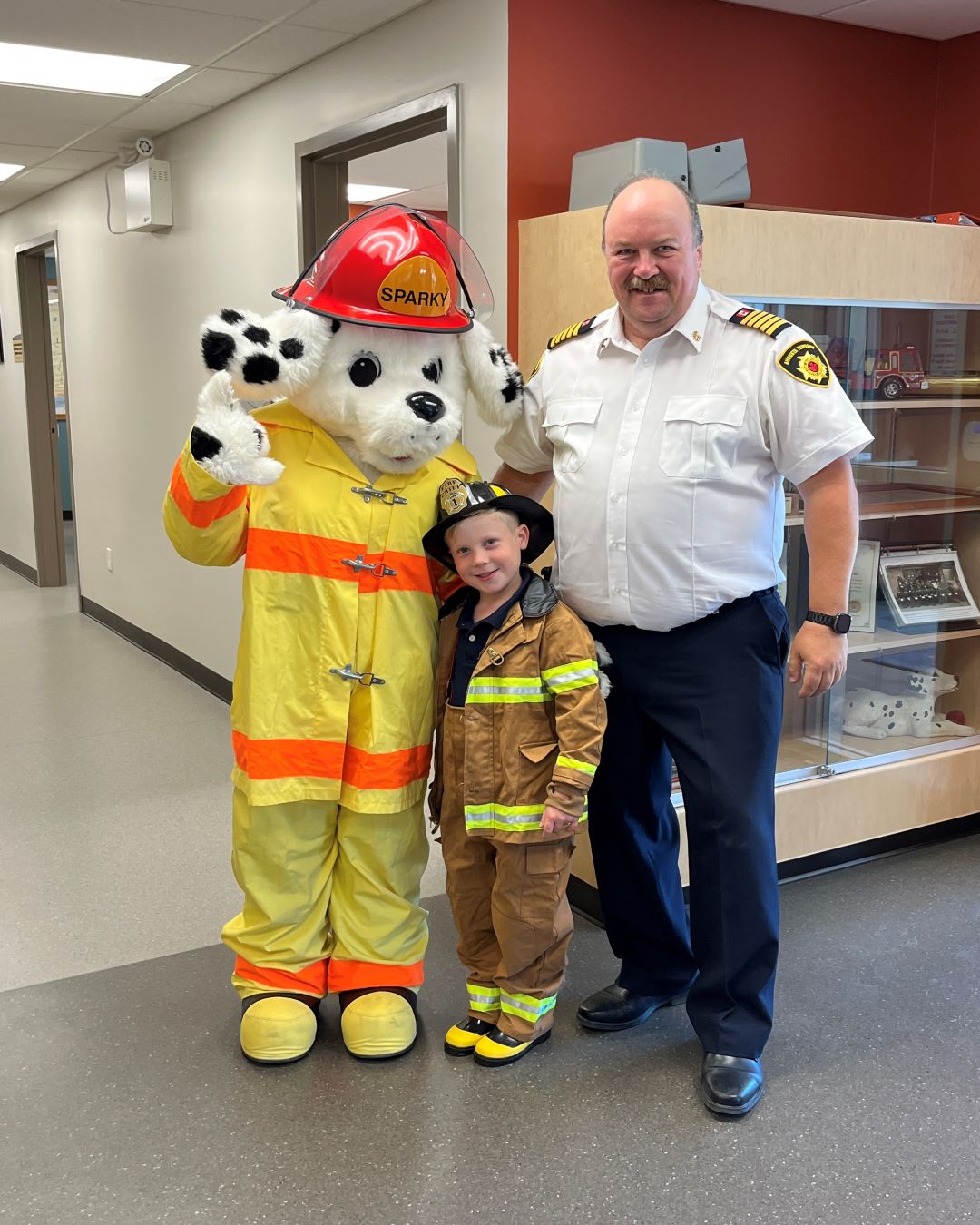Sparky, Connor (fire chief of the day) and Chief Rob Bowman