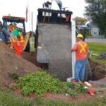 gravel being poured into the hole