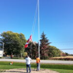 The Canada Flag being reattached and raise back into place