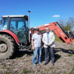 Deputy Mayor Adrian Wynands and Chief Administrative Officer Shannon Geraghty standing in front of a tractor in a field