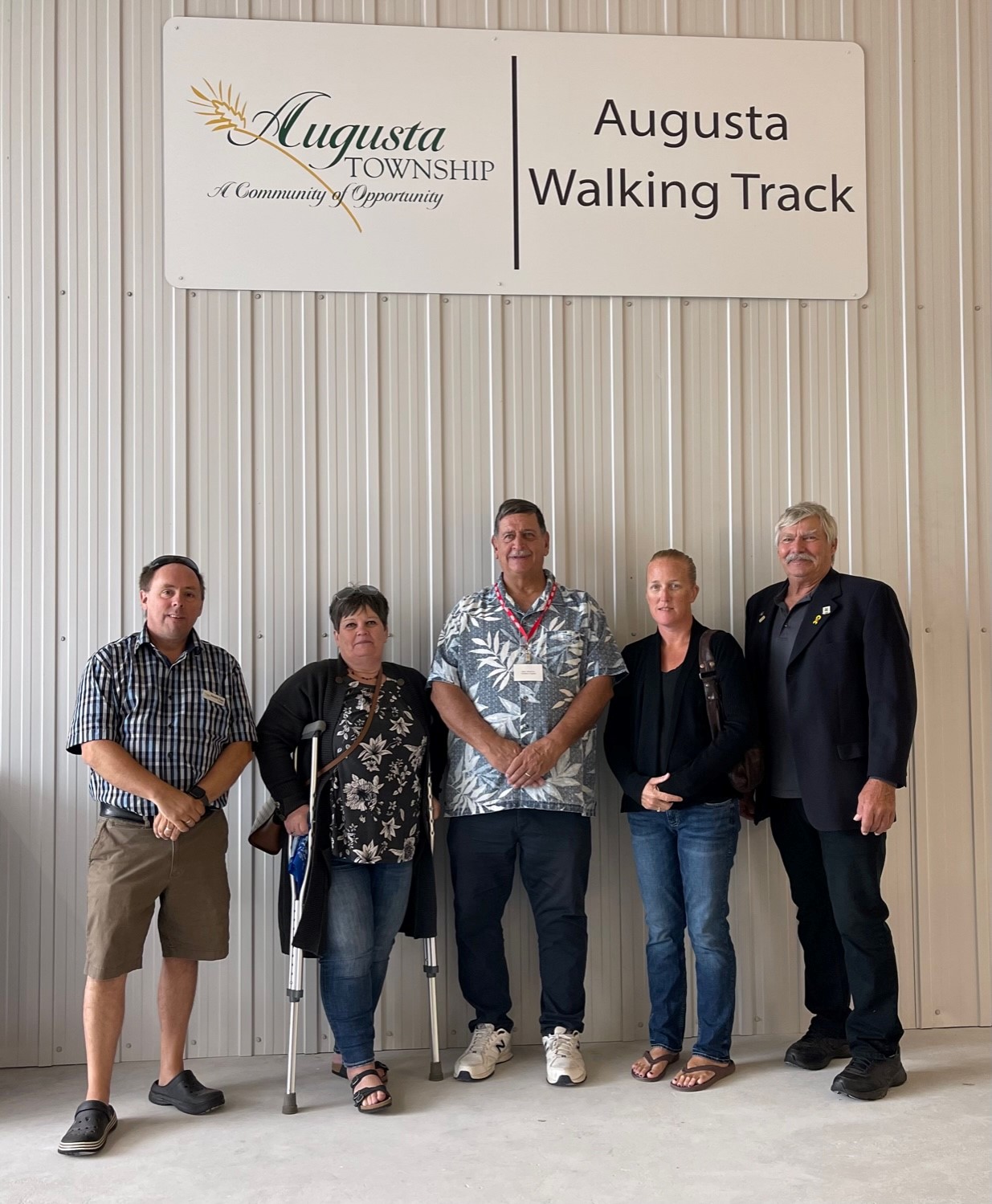 council in front of a sign that says Augusta walking track